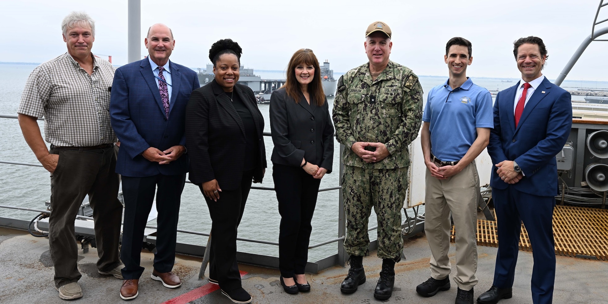 Assistant Secretary of the Navy (Manpower and Reserve Affairs) [far right], Mr. C Scott Duncan, Rear Adm. Philip E. Sobeck, Commander, Military Sealift Command [second from the right], and ship tour members, pose for a photo aboard USNS Patuxent (T-AO 201) during a ship tour, Aug.13, 2025.