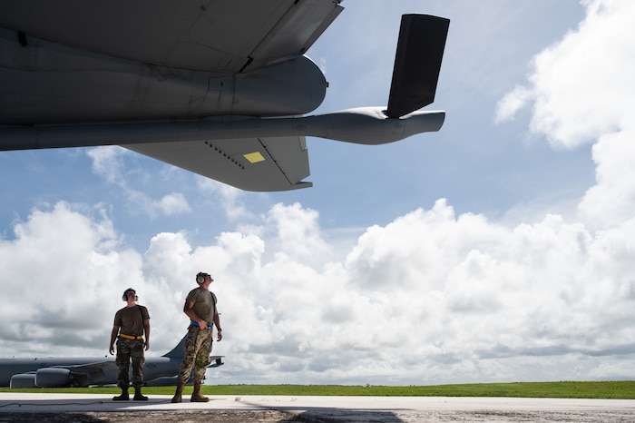 Airman 1st Class Cameron Zorns, 6th Aircraft Maintenance Squadron crew chief, and Staff Sgt. Adam Fall, 6th AMXS flying crew chief, survey the boom of a KC-135 Stratotanker aircraft, while conducting pre-flight checks during the Air Force's Department-Level Exercise series at Andersen Air Force Base, Guam, July 15, 2025. The DLE strengthens and demonstrates the USAF's ability to reach theater at speed and scale, sustain operations, and rapidly pivot to any theater of operation at a moment’s notice, while maintaining the strategic initiative. The DLE series encompasses all branches of the Department of Defense, along with Allies and partners, employing more than 400 joint and coalition aircraft and more than 12,000 personnel across more than 50 locations across 3,000 miles. (U.S. Air Force photo by Staff Sgt. Tryphena Mayhugh)