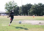 Senior Airman Ebenezer Owusu Arthur, 59th Medical Wing, takes a penalty kick during a photo shoot recognizing his achievements at a military-only soccer tournament in Utah.