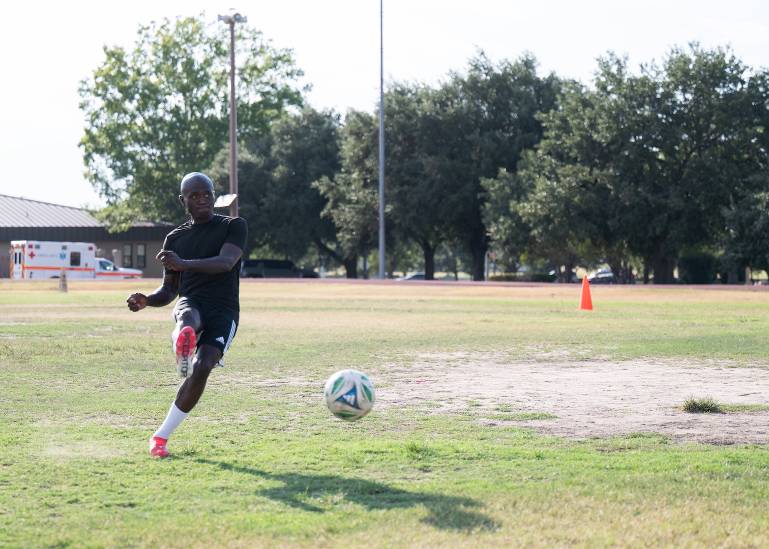 Senior Airman Ebenezer Owusu Arthur, 59th Medical Wing, takes a penalty kick during a photo shoot recognizing his achievements at a military-only soccer tournament in Utah.