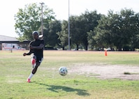 Senior Airman Ebenezer Owusu Arthur, 59th Medical Wing, takes a penalty kick during a photo shoot recognizing his achievements at a military-only soccer tournament in Utah.