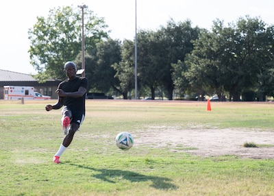 Senior Airman Ebenezer Owusu Arthur, 59th Medical Wing, takes a penalty kick during a photo shoot recognizing his achievements at a military-only soccer tournament in Utah.