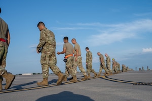 Airmen from the 722nd Aircraft Maintenance Squadron and the 22nd Maintenance Squadron participate in a weekly foreign object debris (FOD) walk at McConnell Air Force Base, Kansas, Aug. 12, 2025. The maintenance teams collected over 1 pound of FOD. (U.S. Air Force photo by Airman 1st Class Paula Arce)