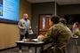 Mike Tucci, Military and Family Readiness Center personal financial counselor, gives Barksdale Airmen a post-deployment briefing at Barksdale Air Force Base, Louisiana, Aug. 6, 2025. Financial advice is one of the many services Airmen can receive from the Military and Family Readiness Center. (U.S. Air Force photo by Airman 1st Class Aaron Hill)