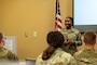 U.S. Air Force Master Sgt. Jasmine Tanner, Military and Family Readiness Center readiness noncommissioned officer in charge, gives a post deployment brief to Barksdale Airmen at Barksdale Air Force Base, Louisiana, Aug. 6, 2025. Post deployment briefs bring together resources from different agencies to help Airmen reintegrate from deployment. (U.S. Air Force photo by Airman 1st Class Aaron Hill)