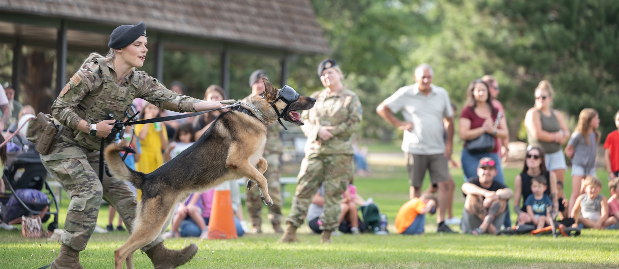 Senior Airman Manzoeillo holds Jagd her military working dog as a part of the demonstration held at National Day Out.