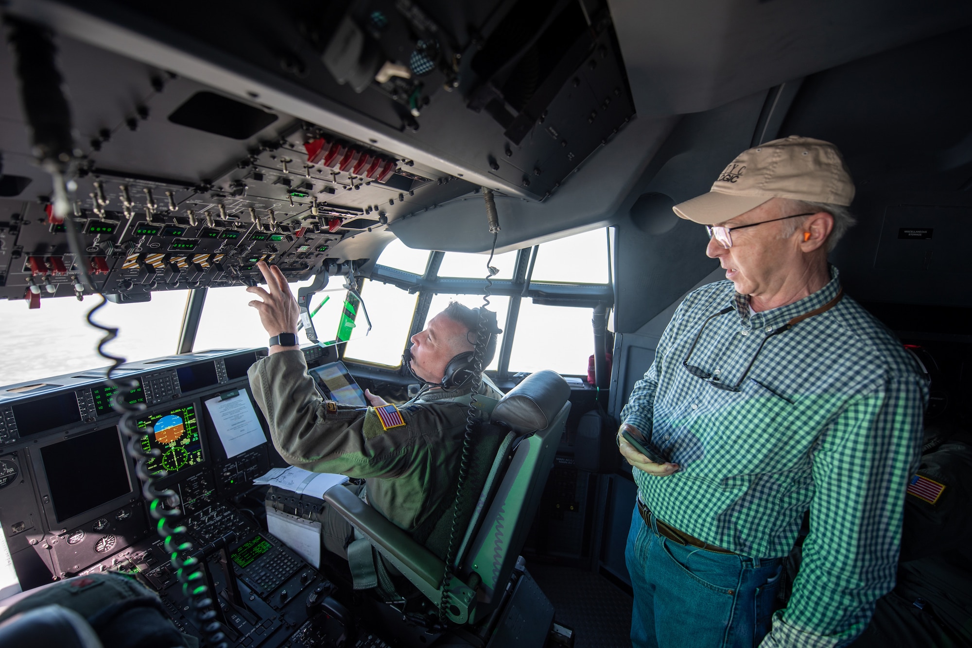 A civilian employer observes flight deck operations aboard a Kentucky Air National Guard C-130J Super Hercules aircraft en route to Paducah, Ky., May 14, 2025, for an earthquake-response exercise. A group of employers participated in the orientation flight as part of an Employer Support of the Guard and Reserve “Bosslift,” a federal program designed to enhance their understanding of Guard missions by offering an inside perspective on military operations. (U.S. Air National Guard photo by Phil Speck)