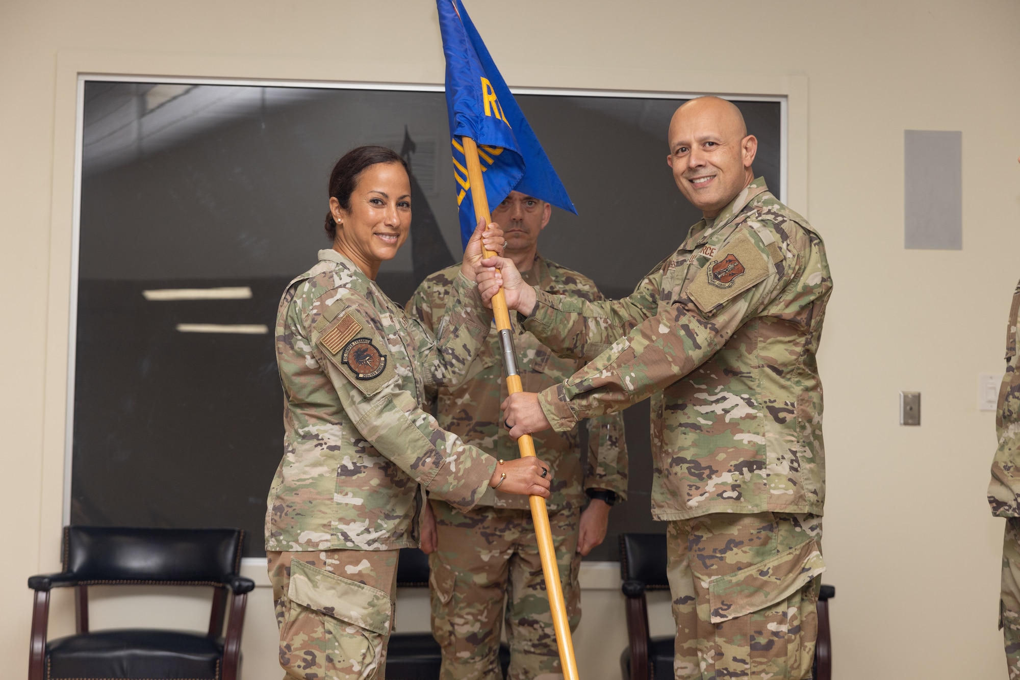 Abisaab handing guidon to Burge