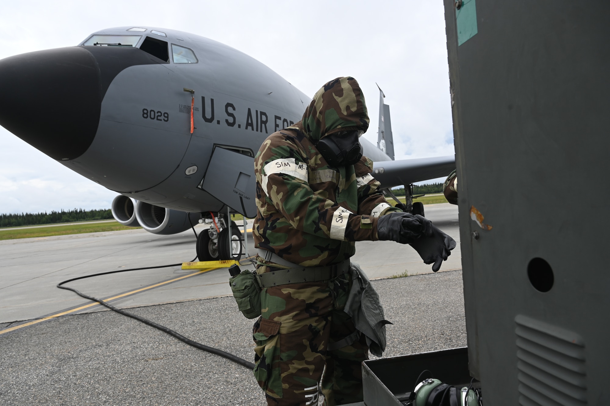 A 168th Wing crew chief dons chemical warfare gear while surving and operating and launching KC-135 Stratotanker operations.