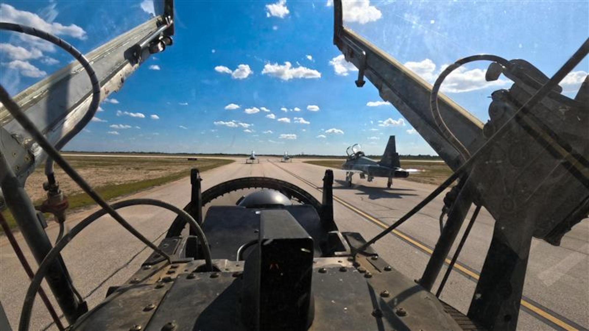 A formation of T-38C Talon aircraft taxis onto the runway during a non-standard airspace training exercise at Laughlin Air Force Base, Texas, Aug. 7, 2025. The event focused on fighter and bomber fundamentals, challenging instructor pilots to operate in dynamic, high-tempo environments. (U.S. Air Force photo by Airman 1st Class Harrison Sullivan)