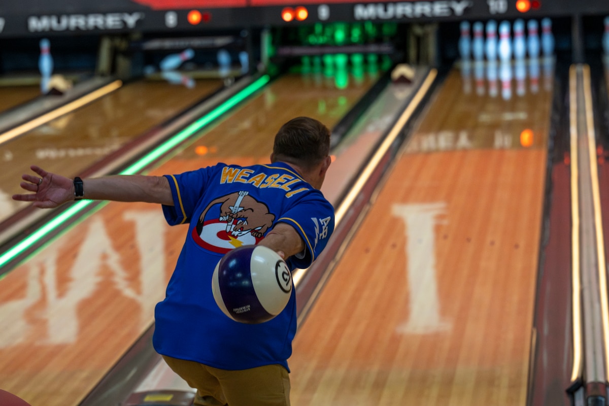 U.S. Air Force Col. Paul Davidson, 35th Fighter Wing commander, prepares to roll a bowling ball down a lane during a friendship bowling event at Misawa Air Base, Japan, Aug. 9, 2025.