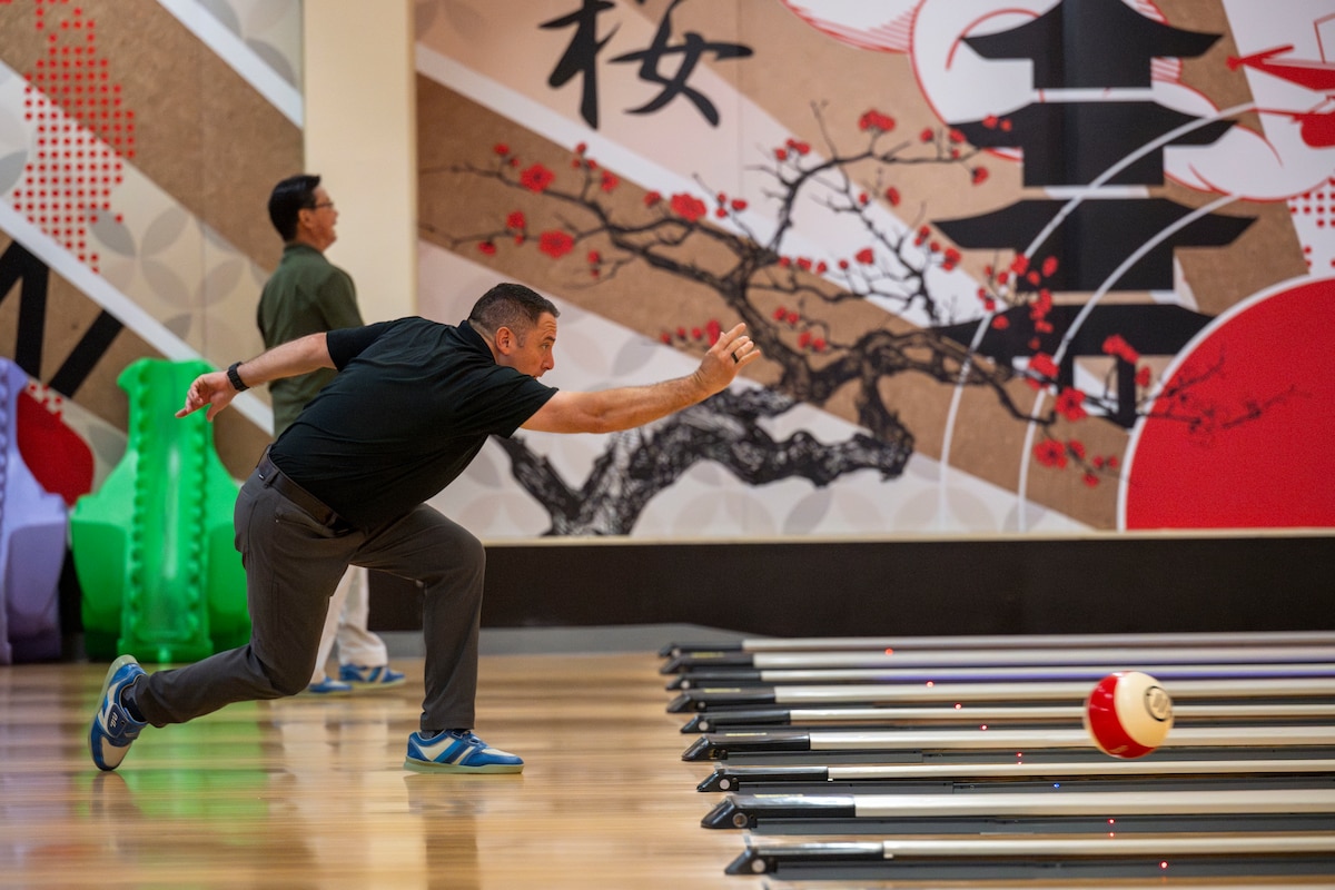 A participant rolls a bowling ball down a lane during a friendship bowling event at Misawa Air Base, Japan, Aug. 9, 2025.