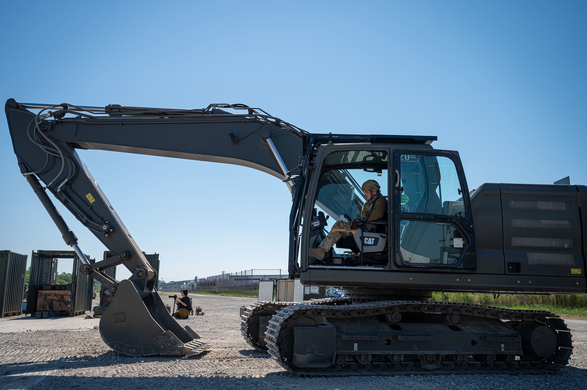 Airman  operates an excavator.