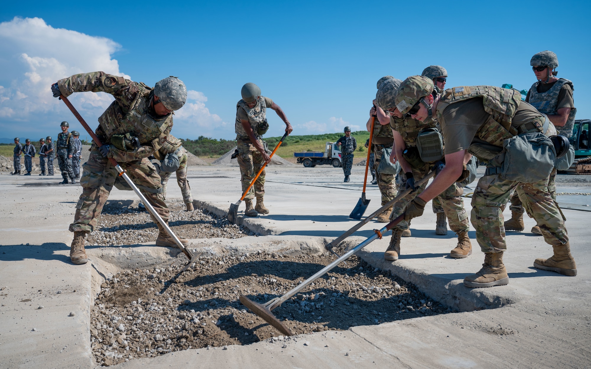 Airmen excavate a damaged section of runway.