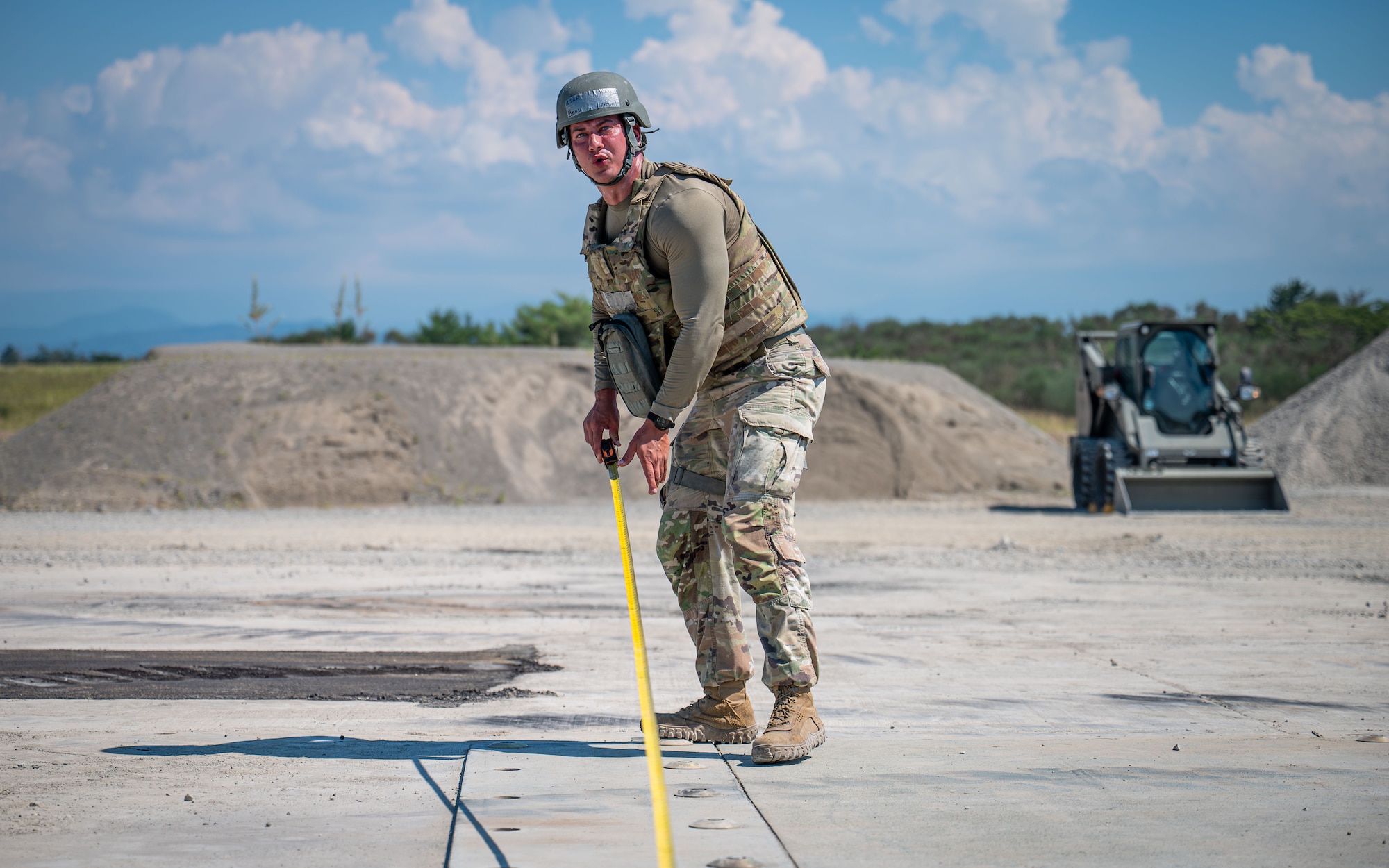 Airman measures a piece of fiberglass.