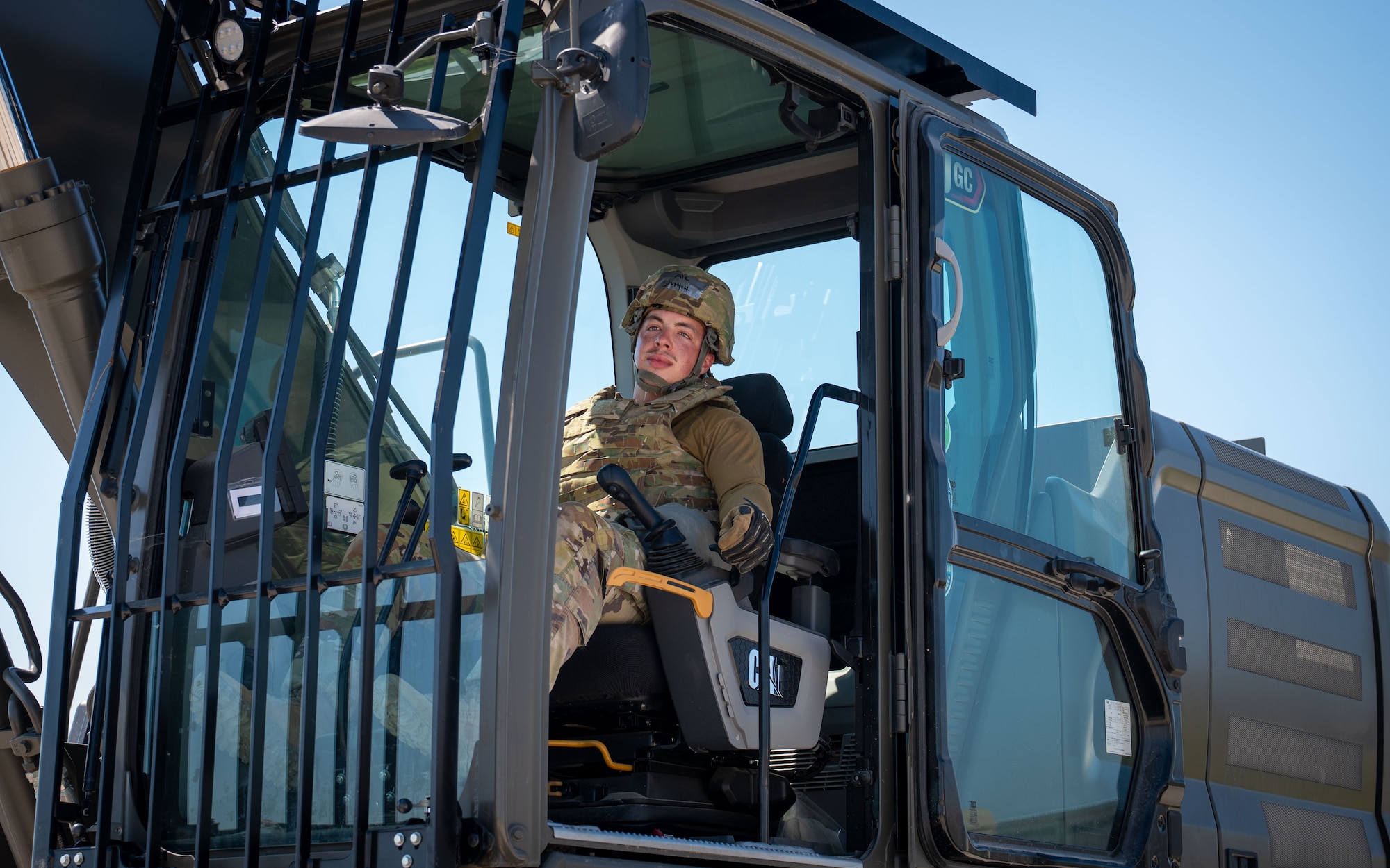 Airman operates an excavator.