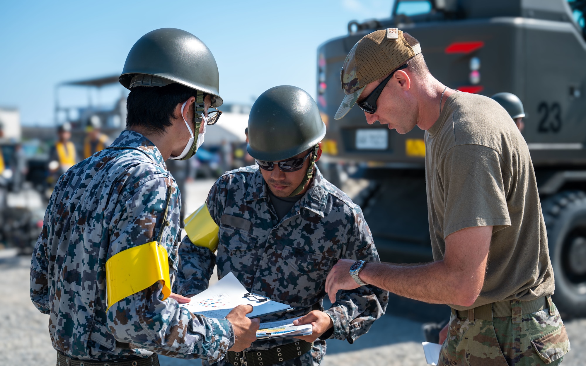 U.S. Air Force Airmen and Japan Air Self Defense Force personnel discuss.