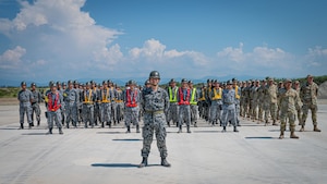 Service members stand in formation.