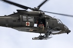 Alaska Army National Guard HH-60M MEDEVAC Black Hawk aviators assigned to Golf Company, 2-211th General Support Aviation Battalion, conduct a hoist training demonstration while hosting mission partners for a multi-agency hoist symposium at Bryant Army Airfield on Joint Base Elmendorf-Richardson, Alaska, July 21, 2025. The AKARNG Dustoff aviators collaborated with U.S. Coast Guardsmen assigned to Sector Western Alaska and U.S. Arctic out of Kodiak and Sitka Air Stations, Alaska Air National Guardsmen with the 176th Wing rescue squadrons, U.S. Army aviators from Fort Wainwright’s 1-52 General Support Aviation Battalion, Alaska State Troopers, and civilian search and rescue professional volunteers from the Alaska Mountain Rescue Group. The collaborative training drew on the participants’ varied backgrounds, experiences, and practices, to enhance hoist proficiency and collective readiness when conducting life-saving search and rescue missions in Alaska’s vast and austere terrain. (Alaska Army National Guard photo by Alejandro Peña)