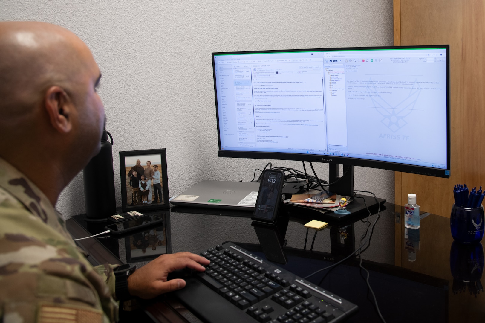 Master Sgt. Eric Tabor looks at his computer screen at his desk.