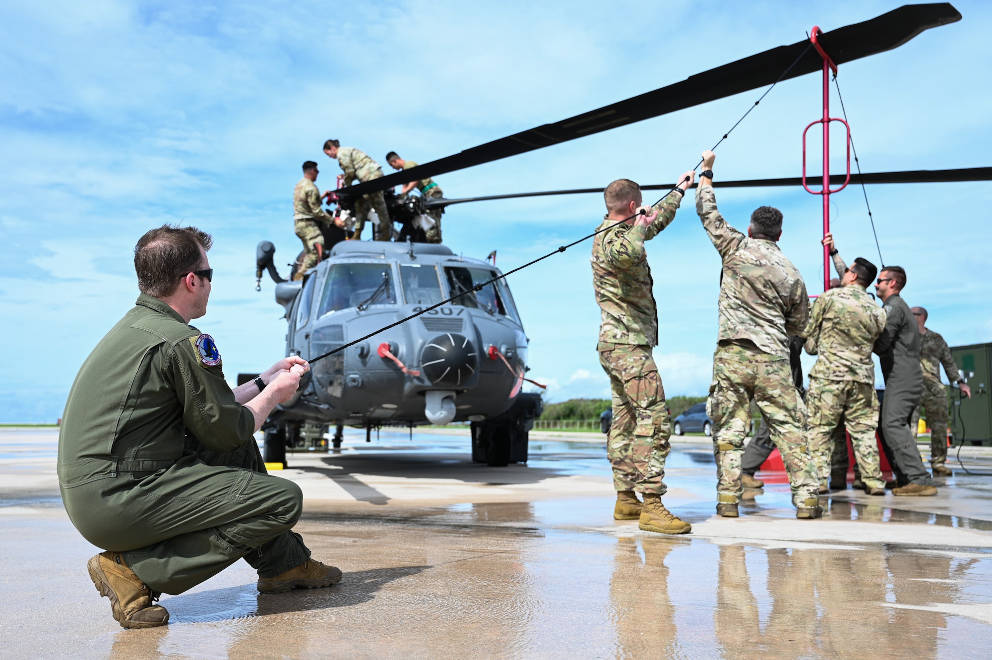 Airmen prepare a helicopter for training.