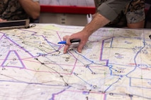 U.S. Marine Corps Capt. Wyatt Mathews, from Wyoming, a CH-53E Super Stallion pilot with Marine Heavy Helicopter Squadron (HMH) 461, Marine Aircraft Group 29, 2nd Marine Aircraft Wing (MAW), studies a map during simulated mission planning as part of Assault Support Planning Problem (ASPP) 1-26 at Marine Corps Air Station New River, North Carolina, Aug. 7, 2025. ASPP provides pilots with the opportunity to plan, brief and lead a company air assault mission prior to attending the Marine Corps’ Weapons and Tactics Instructor course. (U.S. Marine Corps photo by Cpl. Anakin Smith)