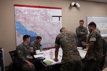 U.S. Marines plan a simulated air assault mission as part of Assault Support Planning Problem (ASPP) 1-26 at Marine Corps Air Station New River, North Carolina, Aug. 7, 2025. ASPP provides pilots with the opportunity to plan, brief and lead a company air assault mission prior to attending the Marine Corps’ Weapons and Tactics Instructor course. (U.S. Marine Corps photo by Cpl. Anakin Smith)