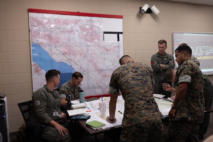 U.S. Marines plan a simulated air assault mission as part of Assault Support Planning Problem (ASPP) 1-26 at Marine Corps Air Station New River, North Carolina, Aug. 7, 2025. ASPP provides pilots with the opportunity to plan, brief and lead a company air assault mission prior to attending the Marine Corps’ Weapons and Tactics Instructor course. (U.S. Marine Corps photo by Cpl. Anakin Smith)