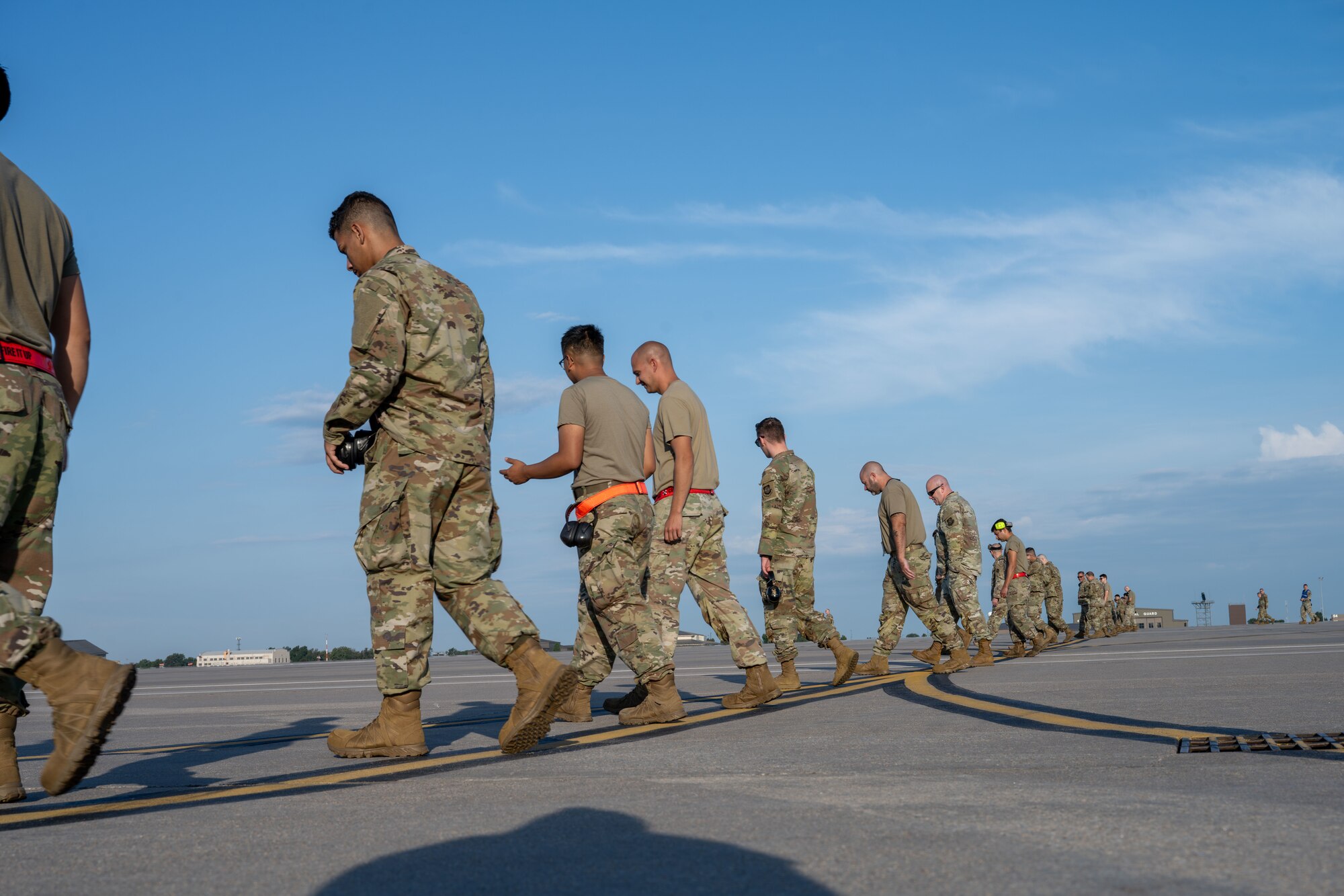 Airmen from the 722nd Aircraft Maintenance Squadron and the 22nd Maintenance Squadron participate in a weekly foreign object debris (FOD) walk at McConnell Air Force Base, Kansas, Aug. 12, 2025. The maintenance teams collected over 1 pound of FOD. (U.S. Air Force photo by Airman 1st Class Paula Arce)