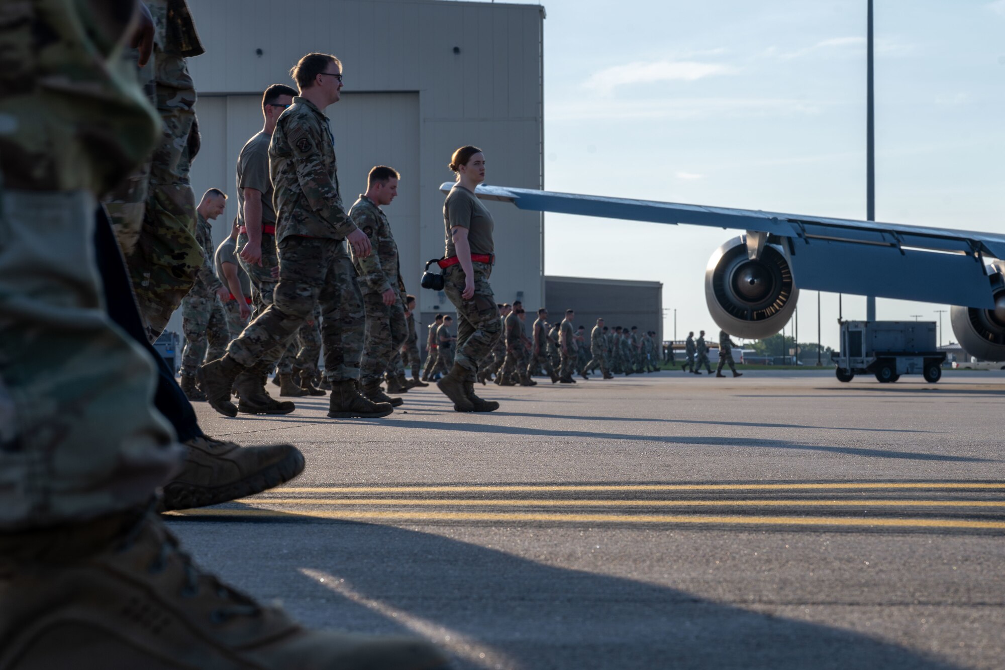 Airmen from the 722nd Aircraft Maintenance Squadron and the 22nd Maintenance Squadron participate in a weekly foreign object debris (FOD) walk at McConnell Air Force Base, Kansas, Aug. 12, 2025. The Airmen were split into two groups and started on opposite sides, meeting in the middle of the flightline. (U.S. Air Force photo by Airman 1st Class Paula Arce)