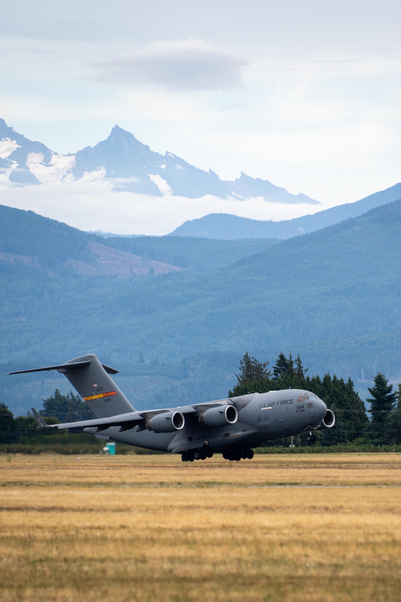 A U.S. Air Force C-17 Globemaster III aircraft assigned to the 58th Airlift Squadron takes off at the Abbotsford International Airport, Canada, Aug. 8, 2025. The 97th Air Mobility Wing demonstration team performed a flyover with unique maneuvers such as a quick-assault landing and reverse thrust. (U.S. Air Force photo by Airman 1st Class Lauren Torres)