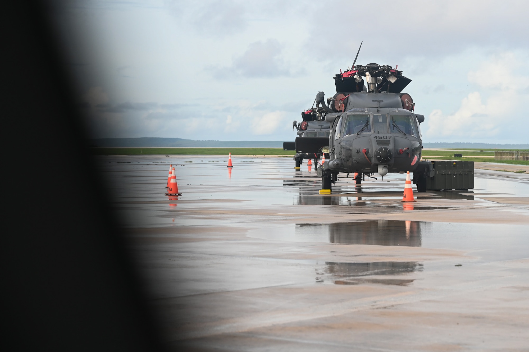 An HH-60W Jolly Green II helicopter sits on the flightline before its blade unfolding during exercise Resolute Force Pacific in Saipan, Northern Mariana Islands, July 11, 2025. REFORPAC is part of the first-in-a-generation Department-Level Exercise series, encompassing all branches of the Department of Defense, along with Allies and partners, employing more than 400 Joint and coalition aircraft and more than 12,000 members at more than 50 locations across 3,000 miles. (U.S. Air Force photo by Senior Airman Andrew Garavito)