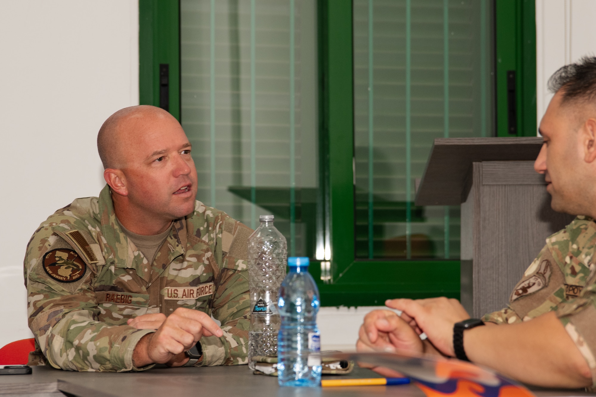 U.S. Air Force Tech. Sgt. John Raebig, 177th alert crew chief, talks to Cyprus Army National Guard Master Sgt. Christodoulos Christodoulou.