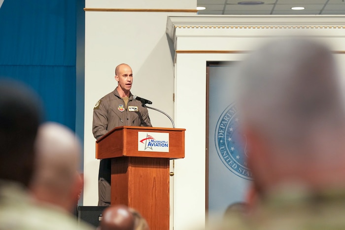 a colonel speaks from behind a podium