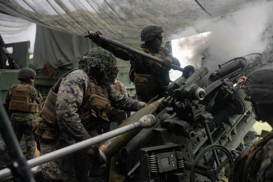 U.S. Marine Corps Sgt. Shemarr MitchellTavares, left, and Lance Cpl. Terrone Thomas, both field artillery cannoneer’s with 1st Battalion, 10th Marine Regiment, 2d Marine Division, load an M777 Howitzer during exercise Burmese Chase 25 on Marine Corps Base Camp Lejeune, North Carolina, Aug. 12, 2025. Burmese Chase is an annual U.S. led, multi-lateral training exercise that incorporates integrating ground and air fires, infantry tactics and naval gunfire. (U.S. Marine Corps photo by Lance Cpl. Hunter J Kuester)