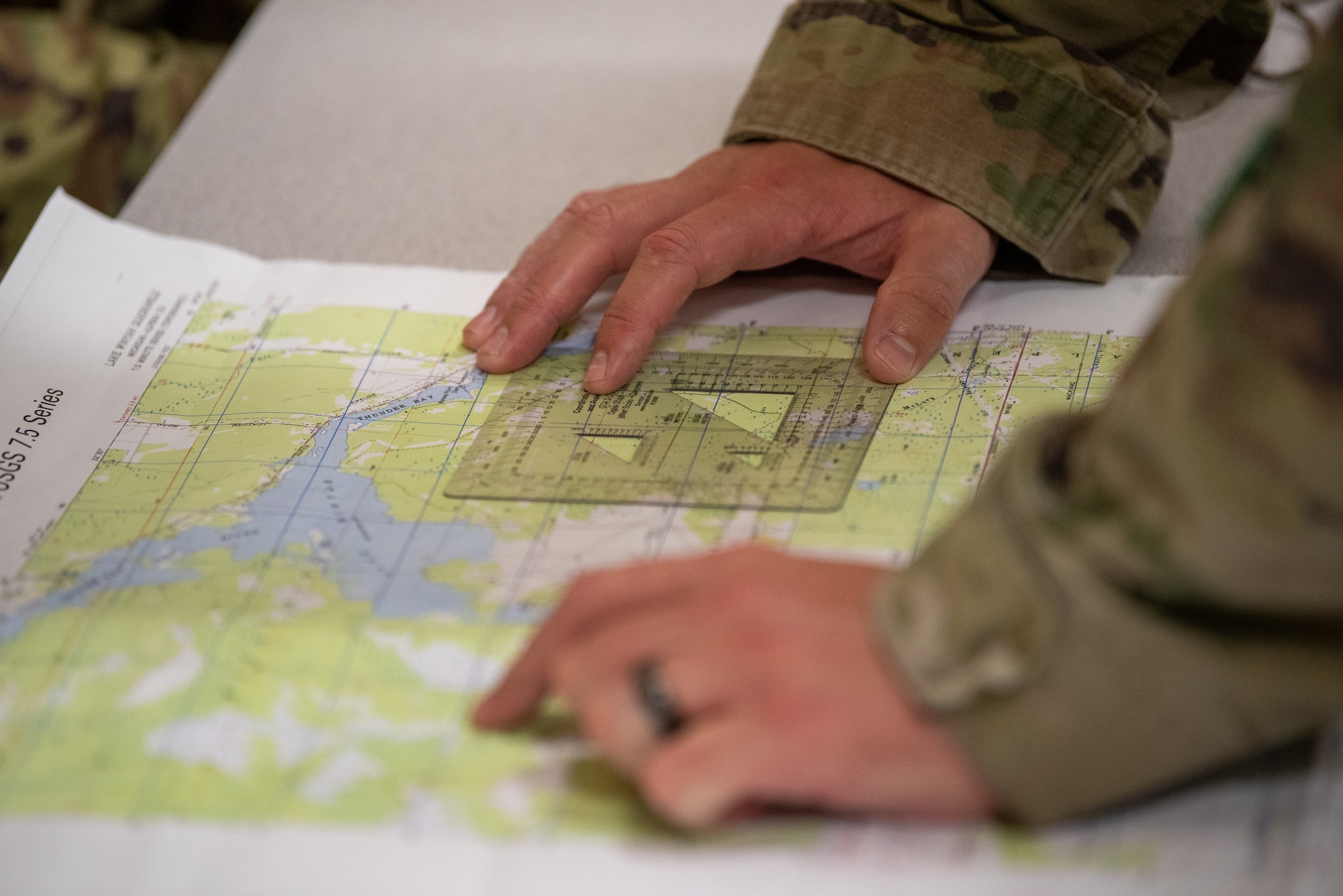 Airmen from the Kentucky Air National Guard’s 123rd Security Forces Squadron and 123rd Contingency Response Group plan routes prior to executing a land navigation course at the Alpena Combat Readiness Training Center in Alpena, Mich., May 22, 2025. More than 50 Airmen from the 123rd SFS and 123rd CRG, along with members of the Colorado Air National Guard’s 233rd  Security Forces Squadron and the Ecuadorian Air Force, participated in a nine-day field exercise here May 21 to 29. (U.S. Air National Guard photo by Phil Speck)