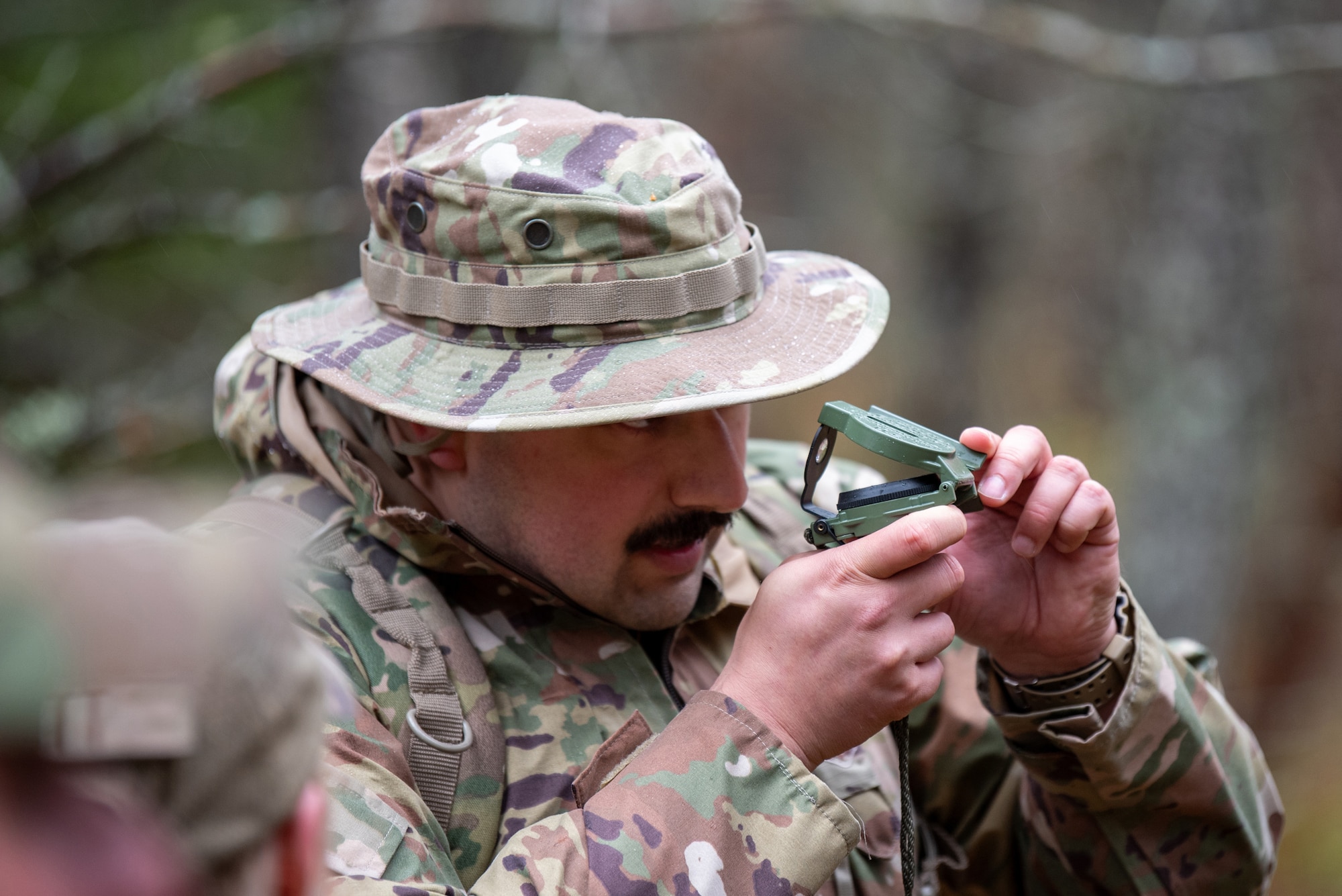 Senior Airman William Ellis, a security forces fireteam member from the Kentucky Air National Guard’s 123rd Contingency Response Group, uses a compass during a land navigation course at the Alpena Combat Readiness Training Center in Alpena, Mich., May 22, 2025. More than 50 Airmen from the Kentucky Air National Guard’s 123rd Security Forces Squadron and 123rd CRG, along with members of the Colorado Air National Guard’s 233rd Security Forces Squadron and the Ecuadorian Air Force, participated in a nine-day field training exercise at Alpena Combat Readiness Training Center from May 21 to 29. (U.S. Air National Guard photo by Phil Speck)