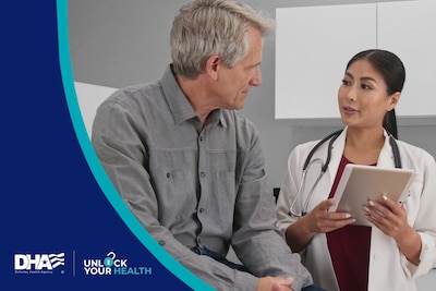 Man in grey shirt speaks to a doctor