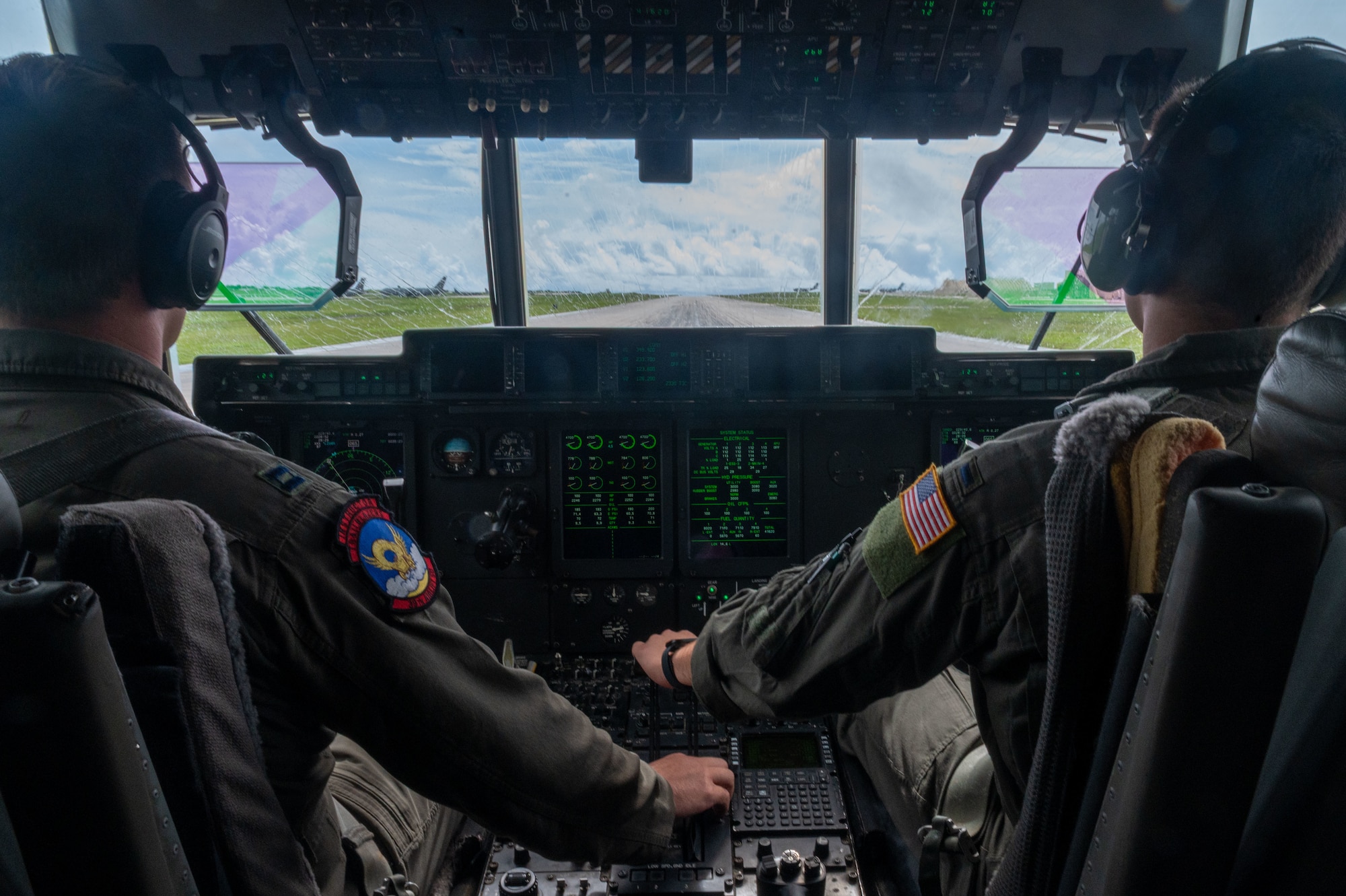 airmen provide patient care in the back of a C-130J Super Hercules