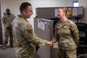 A U.S. Air Force command chief coins on Airman for outstanding performance on Joint Base Pearl Harbor-Hickam, Hawaii.