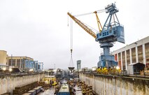 Crane 92 (pictured in 2024, before repainting) will soon sport a darker blue look at Puget Sound Naval Shipyard & Intermediate Maintenance Facility in Bremerton, Washington. A six-person team of painters is working hard throughout the short Pacific Northwest summer to repaint cranes 80, 82 and 92. The paints used are silicone alkyd enamel, with a higher gloss sheen added for ease of cleaning purposes, and for better UV deflection. (U.S. Navy photo by Wendy Hallmark)
