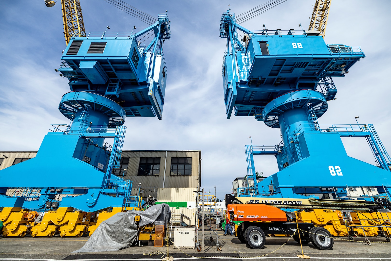 Portal cranes 80 and 82 are pictured after receiving a fresh coat of paint in July of 2025, at Puget Sound Naval Shipyard & Intermediate Maintenance Facility in Bremerton, Washington. A six-person team of painters is working hard throughout the short Pacific Northwest summer to repaint cranes 80, 82 and 92. (U.S. Navy photo by Jeb Fach)