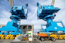 Portal cranes 80 and 82 are pictured after receiving a fresh coat of paint in July of 2025, at Puget Sound Naval Shipyard & Intermediate Maintenance Facility in Bremerton, Washington. A six-person team of painters is working hard throughout the short Pacific Northwest summer to repaint cranes 80, 82 and 92. (U.S. Navy photo by Jeb Fach)