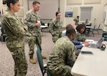 250708-N-N1574-1002 NAPLES, Italy (August 4-8, 2025) Naval Medical Forces Atlantic (NMFL) participate in Large Scale Exercise 2025 (LSE 25) for the first time marking a major milestone. Pictured standing, Patient Movement Officers Lt. Cmdr. Alexandra Gracia, and Lt. Cmdr. Samual Woodson, Hospital Corpsman 2nd Class Sierra Tjader, Future Operations Liaison Officer, and seated, Hospital Corpsman 1st Class Asare Baffour, Mr. Gregory Vinciguerra, Director of Operations, and Lt.j.g Afiya Bradshaw, Future Operations Officer develop Task Group Health Service Support/NMFL’s One Brief site during the exercise. Also seen in the background, Lt. Cmdr. Rannie Gibson, Logistics Officer and Cmdr. Ray Posey NMFL Director, Maritime Operations Center (acting) and Forward Officer in Charge for the exercise, plan for the future Naval Medical Readiness Training Command overseas bed expansion and augmentation requirements based on direction of the Joint Force Maritime Component Commander. LSE 2025 merges real-world operations with virtually constructed scenarios to create a realistic training environment that allows our Sailors and Marines to train the way we fight, regardless of geographic boundaries. (U.S. Navy Photo by Cmdr. Tiffany Lerch)
