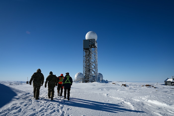 U.S. Air Force Air Combat Command Acquisition Management and Integration Center Detachment 1 team members and other USAF personnel walk up to North Warning System Site CAM-5A.