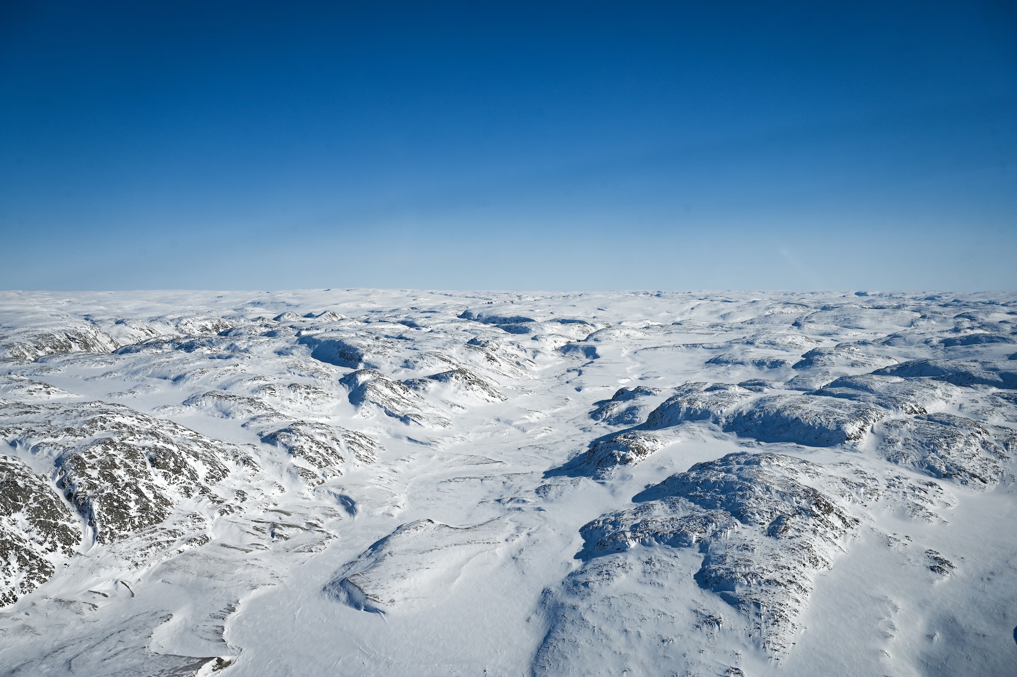 The Arctic tundra is frozen over in the spring at Sanirajak, Nunavut, Canada.