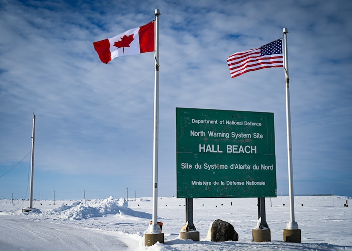 United States and Canadian flags fly at North Warning System Site FOX-M Hall Beach.