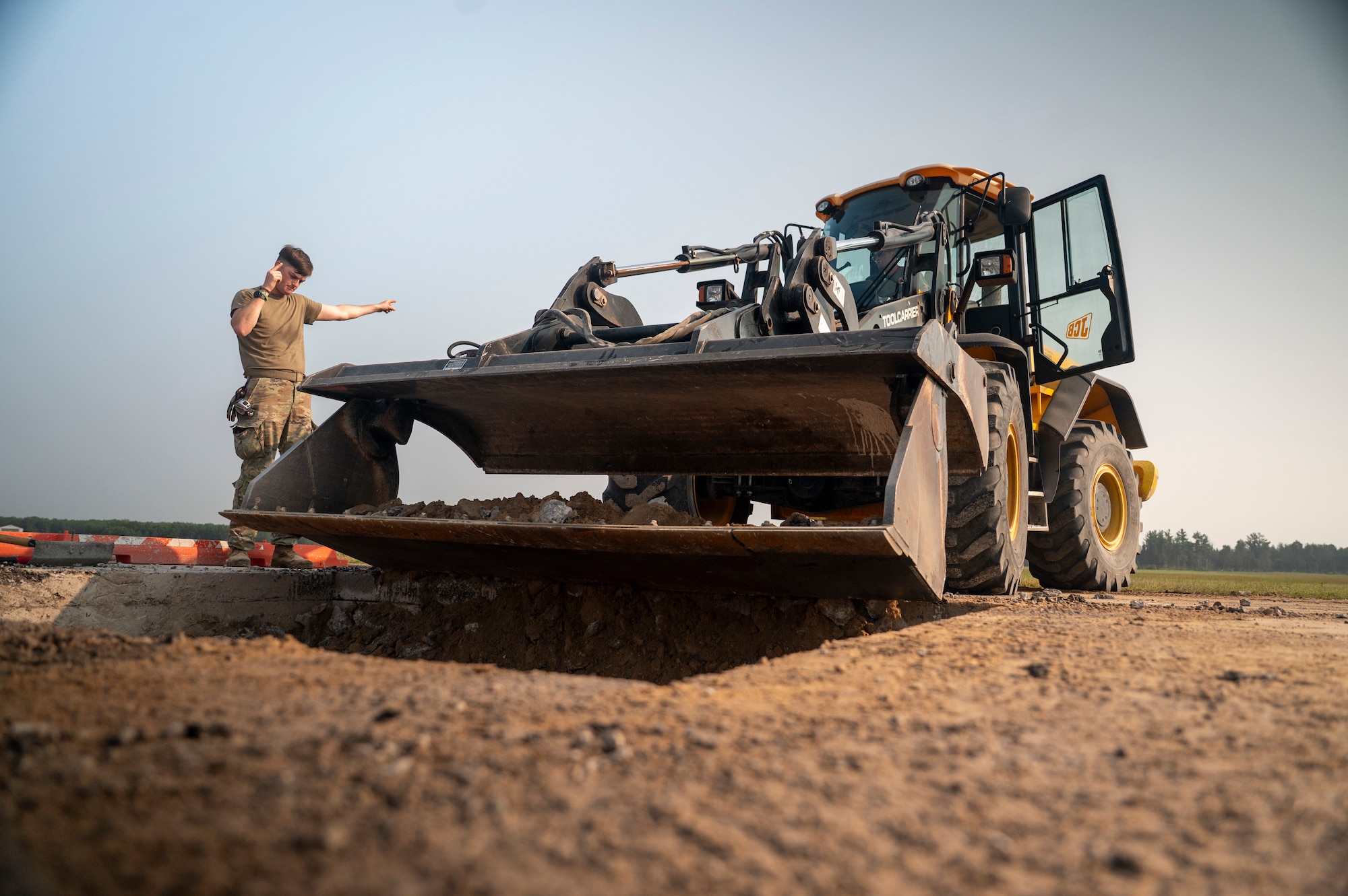 United States Air Force service members perform repairs to an airfield taxiway
