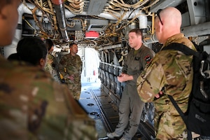 A group of military members inside an aircraft