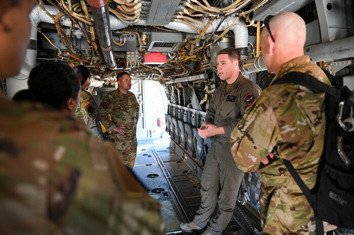 A group of military members inside an aircraft